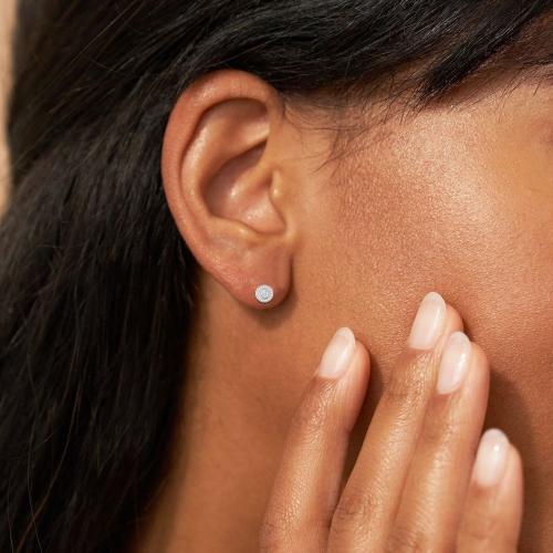 1/2 Ct. T.w. Diamond Round and Baguette Halo Stud Earrings In 14Kt White Gold